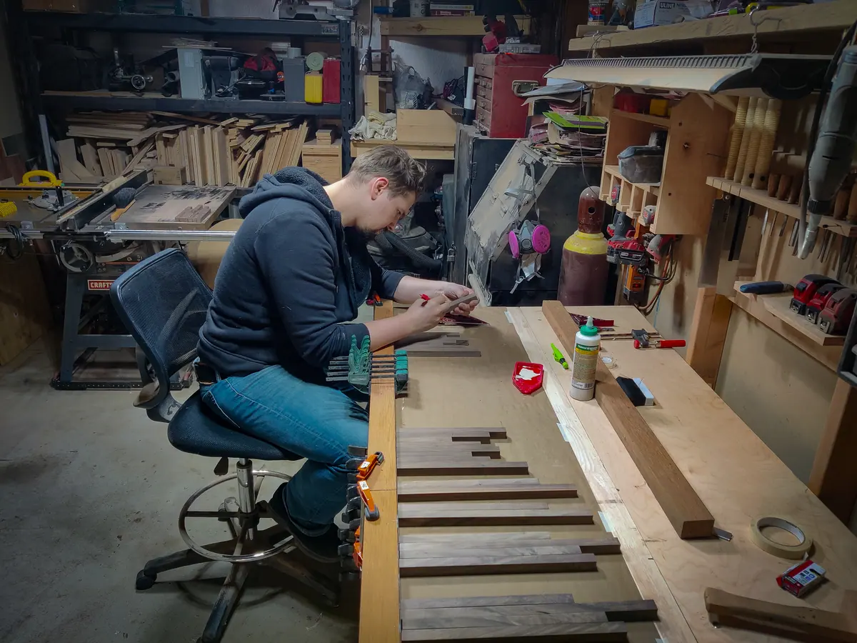 Dan at his workbench, laying out walnut parts